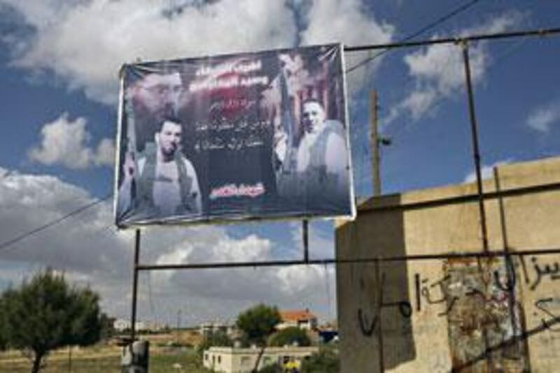 A poster salutes the dead Baalbek fighters, including the suspected drug baron Ali Abbas Jaafar, left, in the Hay al Sharawneh neighbourhood of Baalbek near a Lebanese army checkpoint.