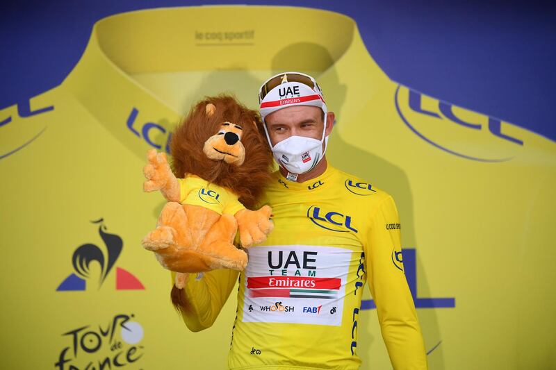 Norwegian rider Alexander Kristoff, of the UAE Team Emirates, celebrates on the podium wearing the overall leader's yellow jersey after winning Stage 1 of the Tour de France on Saturday, August 29. EPA