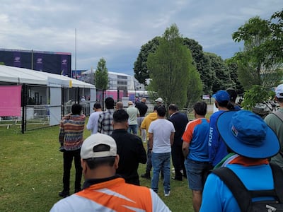 Fans who couldn't get tickets stood outside the Nassau County International Cricket Stadium to try to get a peek at a game screen during the India v Pakistan match. The National