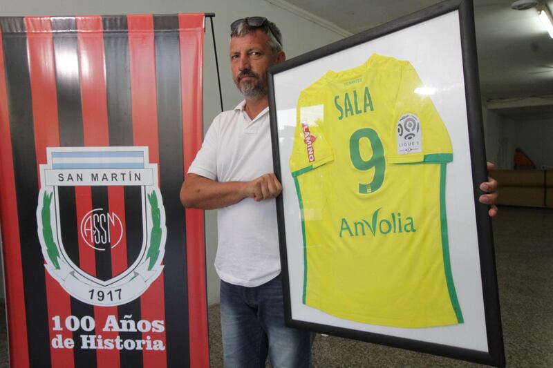 Club Atletico Social San Martin President Daniel Rivero holds a Nantes team jersey that was given to the club by Argentine soccer player Emiliano Sala. AP Photo