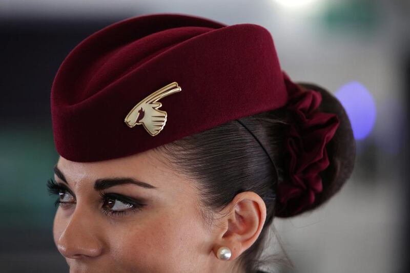 A flight attendant welcomes guests aboard an Airbus A380 operated by Qatar Airways. The airline has 37,000 employees. Jason Alden / Bloomberg