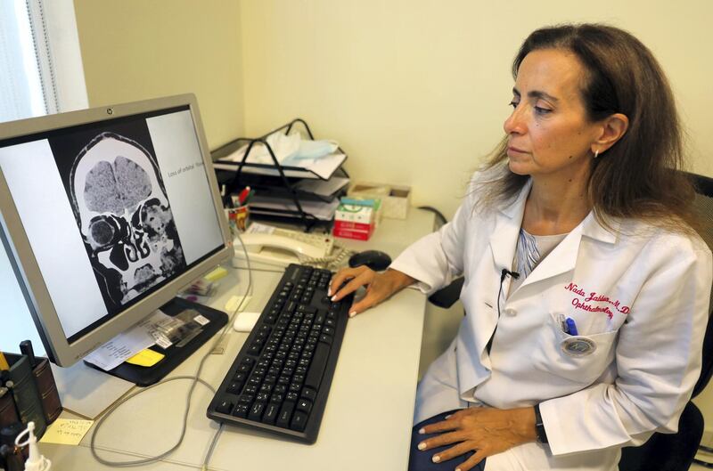 Lebanese doctor Nada Jabbour displays the image of a patient's skull who was hit in the eye with a projectile fired by security forces during an anti-government protest, on August 16, 2020 in Beirut. - Days after the August 4 explosion that destroyed Beirut's port, thousands of angry protesters rallied in the city over the disaster blamed on the corruption and incompetence of Lebanon's ruling class -- already hate-figures of an anti-government protest movement that kicked off in October. Heavy deployments of security forces and plain clothes personnel fired tear gas, rubber bullets and pump action birdshot pellets in an effort to disperse demonstrators, according to protesters and rights groups. (Photo by ANWAR AMRO / AFP)