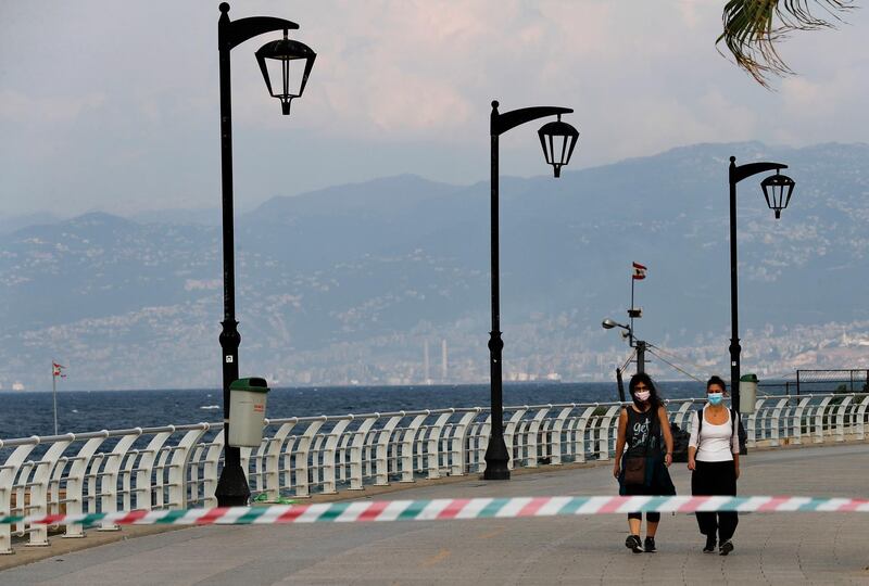 Two women walk on the deserted corniche along the Mediterranean Sea, as Lebanon began a two-week lockdown, in Beirut. AP Photo