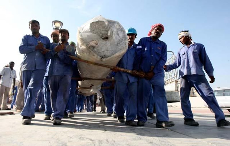 DUBAI, UNITED ARAB EMIRATES Ð May 26, 2011: Workers carrying the carpet roll at the Al Farooq mosque in Al Safa area in Dubai. (Pawan Singh / The National) For News. Story by James