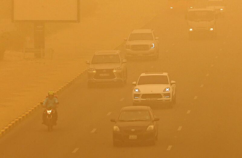 Motorists caught in the sandstorm in Kuwait City. Schools were closed for the day, due to the weather conditions. AFP