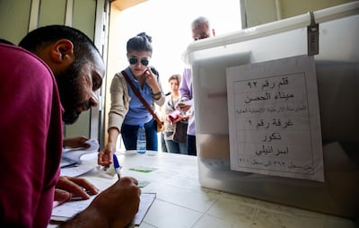 A Lebanese government employee registers the information of an electoral registrar arriving to receive a sealed electoral ballot box containing blank ballots marked for the Lebanese "Israelite" (Jewish) minority -- according to Lebanese confessional voting rules -- at a government office in the capital Beirut on Many 5, 2018. / AFP PHOTO / ANWAR AMRO