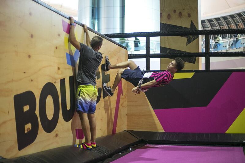 An instructor shows a visitor how to perform maneuvers using a wall at the opening of Bounce Abu Dhabi in Marina Mall. Mona Al Marzooqi / The National