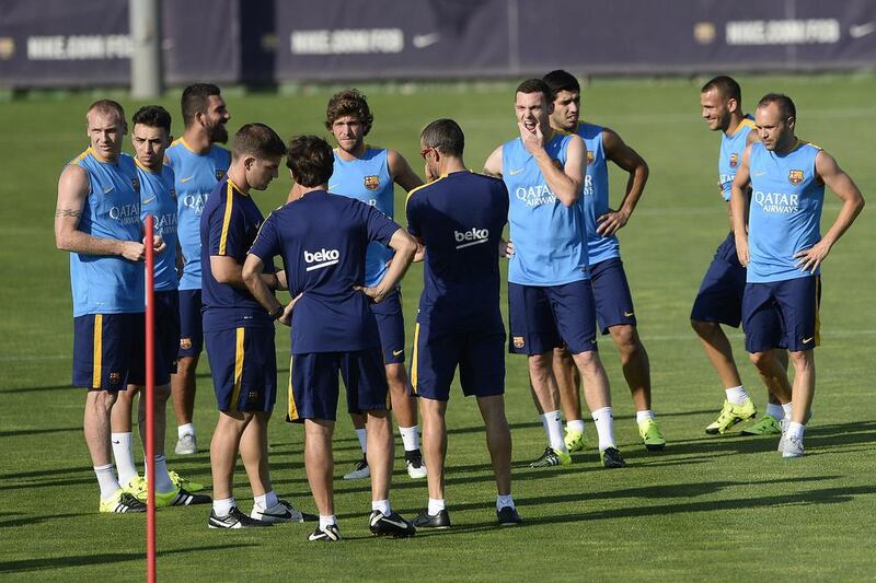 Barcelona coach Luis Enrique, centre, talks to his players. Josep Lago / AFP / July 13, 2015