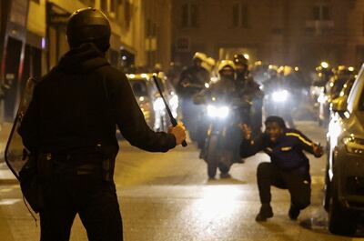 A police officer holds a baton during protests following the death of Nahel. Reuters 
