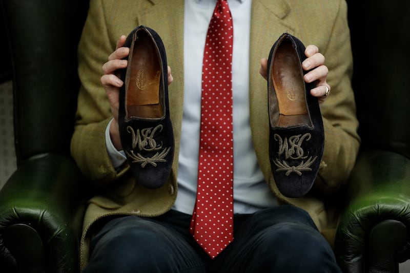 A pair of former British prime minister Sir Winston Churchill's monogrammed velvet slippers were auctioned off. AP