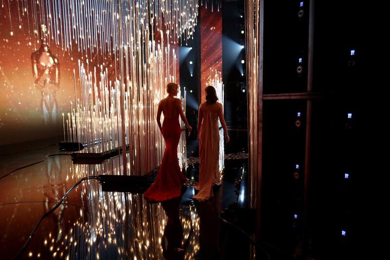 Charlize Theron and Emily Blunt walk onstage.AFP