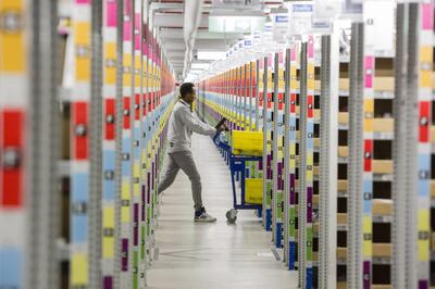 An employee pushes a cart between aisles of merchandise inside an Amazon.com Inc fulfilment centre in Koblenz, Germany. The UPU is an enabler of e-commerce inclusion across the world. Bloomberg