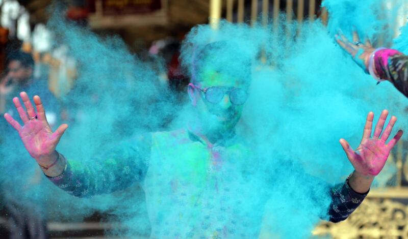 Young Indian men throw powdered colour at each other during Holi festival celebrations at Sri Laxmi Narayan Temple in Amritsar, India, 09 March 2020. Holi is marked at the end of the winter season on the last full moon day of the lunar month, which usually falls in the later part of February or March, and is celebrated by people throwing coloured powder and coloured water at each other. EPA