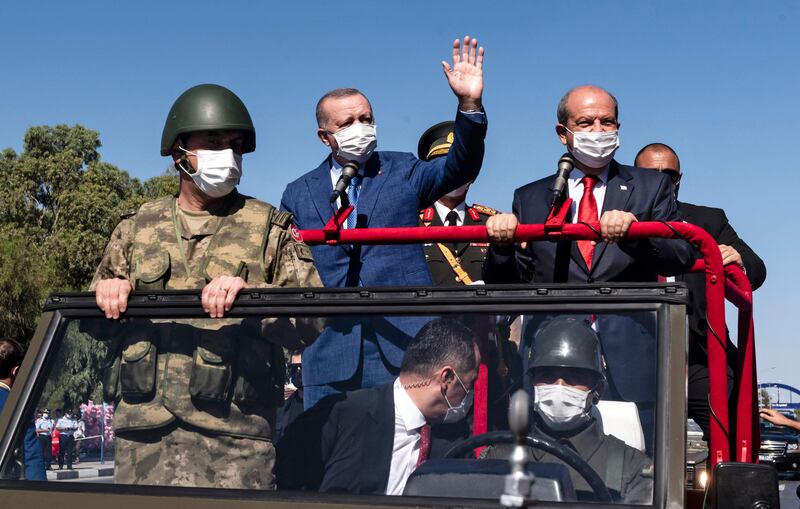 Turkey’s President Recep Tayyip Erdogan waves as he takes part in a parade in Nicosia, Cyprus. AFP
