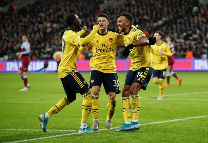 Arsenal's Pierre-Emerick Aubameyang celebrates scoring their third goal with teammates Nicolas Pepe and Gabriel Martinelli. Reuters