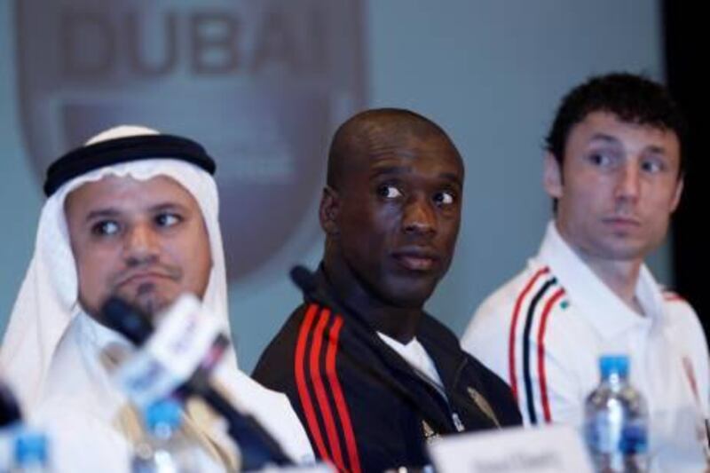AC Milan's Clarence Seedorf (C) and Mark van Bommel (R) attend a news conference in Dubai January 2, 2012. The team arrived in Dubai for their winter training camp, and will play against Paris Saint Germain during the Dubai Football Challenge on January 4, 2012. REUTERS/Ahmed Jadallah (UNITED ARAB EMIRATES - Tags: SPORT SOCCER MEDIA) *** Local Caption ***  AJS05_DUBAI-_0102_11.JPG