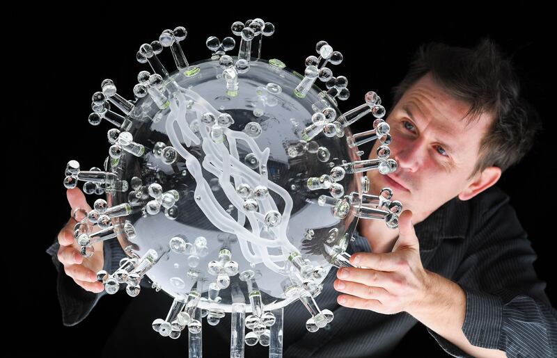 Artist Luke Jerram with his new giant glass sculpture of the Covid-19 virus in Bristol. The sculpture marks the anniversary of the UK’s first national lockdown, on 23rd March 2020. Getty Images