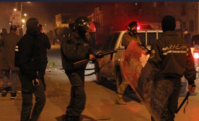 Police officers face demonstrators during  clashes with security forces in the Ettadhamen city suburb of Tunis, Tunisia. A wave of nocturnal demonstrations has rocked the country since 16 January.  EPA