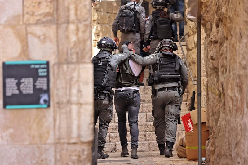 Israeli security forces detain a Palestinian protester amid clashes in Jerusalem's Old City on May 10, 2021. AFP