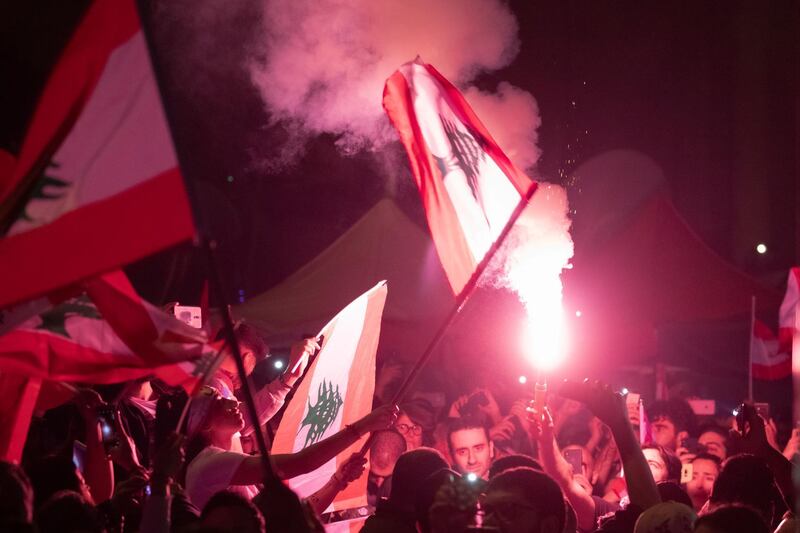 epa08018260 Protesters wave their national flag, during a mass protest in Martyr Square, Beirut, Lebanon, 22 November 2019. Lebanon celebrates the 76th anniversary of its independence with protesters marking the day by holding various events, as marching in groups of Doctors, lawyers, engineers, industrialists, women's associations, retired soldiers and army officers, for their vindication to obtain political changes.  EPA/ANDRE PAIN