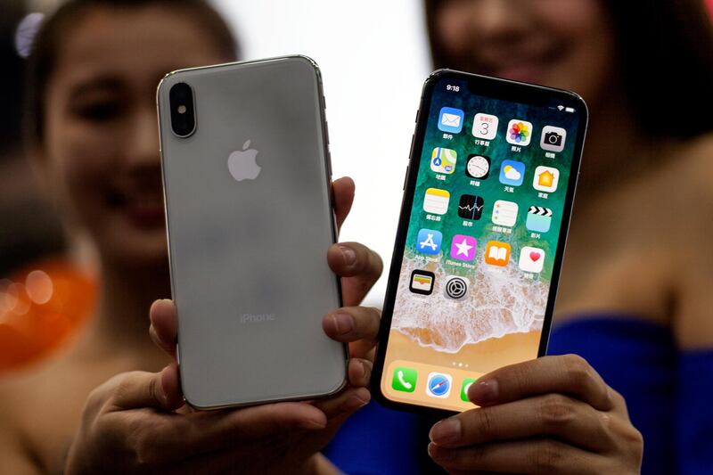 epa06305153 Taiwanese women hold the new Apple iPhone X at an Apple store in Taipei, Taiwan, 03 November 2017. Apple's new iPhone X goes on sale in more than 55 countries and territories on 03 November.  EPA/RITCHIE B. TONGO