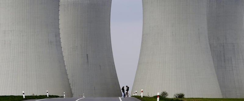 People stand between cooling towers of the Temelin nuclear power plant near the South Bohemian city of Tyn and Vltavou. David W Cerny / Reuters
