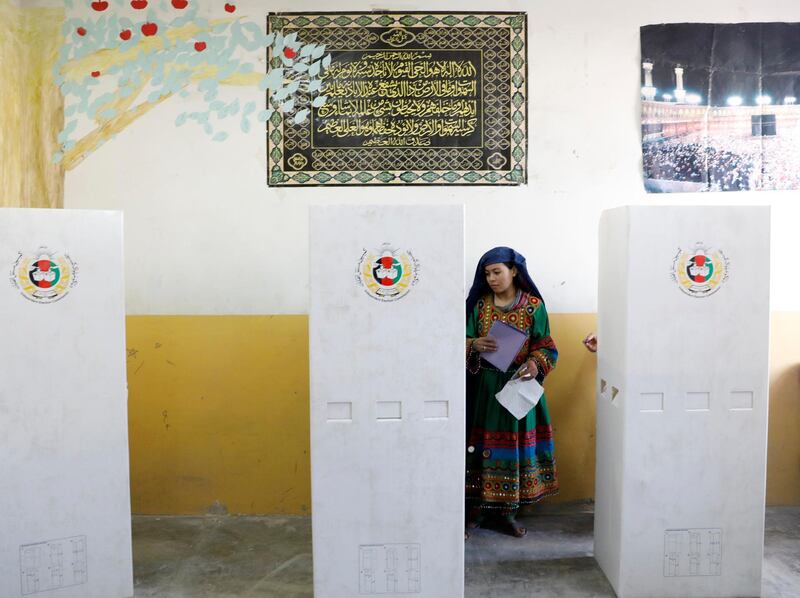 An Afghan woman casts her vote during parliamentary elections at a polling station in Kabul, Afghanistan. Reuters