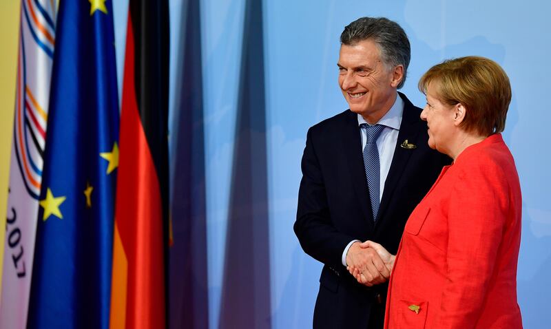 German Chancellor Angela Merkel welcomes Argentinia's president Mauricio Macri. Tobias Schwarz / AFP Photo