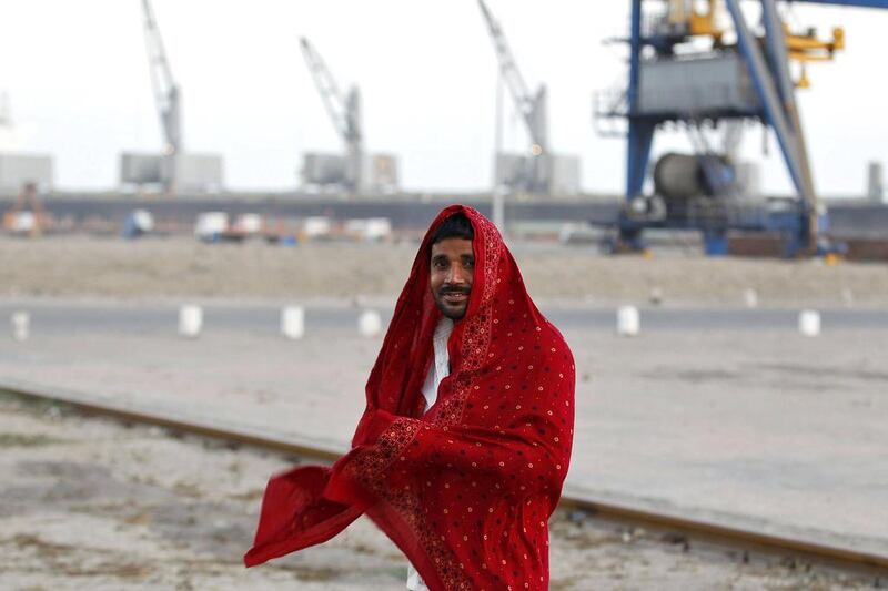 A worker wraps himself with a cloth after his shift was over at Mundra Port. Amit Dave / Reuters