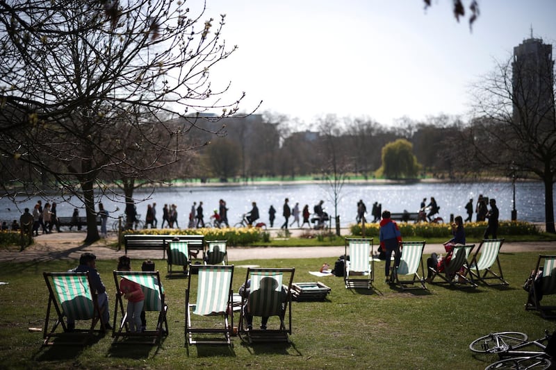 People relax in sunny weather in Hyde Park. Reuters