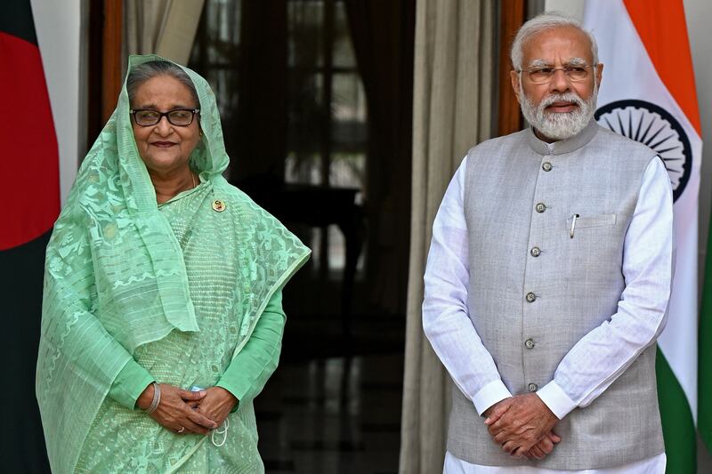 India's Prime Minister Narendra Modi (R) and his Bangladesh’s counterpart Sheikh Hasina pose for pictures before their meeting at the Hyderabad House in New Delhi on Tuesday. AFP