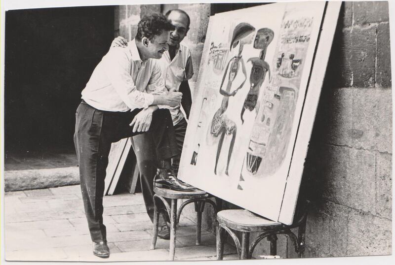 An undated image of Egyptian artist Hamed Nada standing in front of his artwork. Courtesy of ArtTalks, Egypt Archive