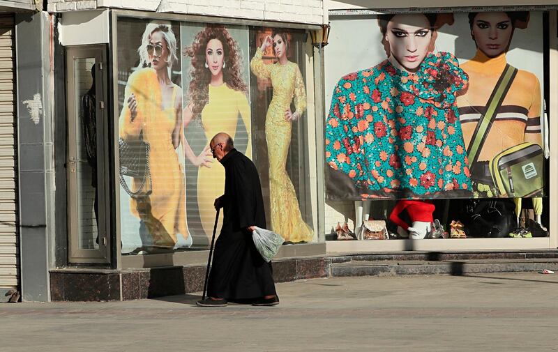 A man walks past shops that are shuttered to help prevent the spread of the coronavirus, in Baghdad, Iraq. AP Photo