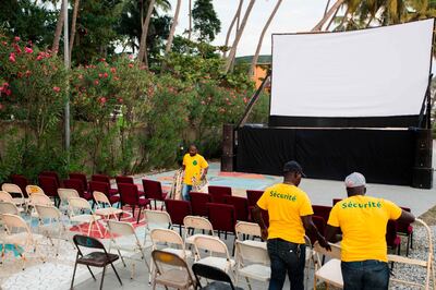 People set up for a film projection next to the beach as part of the Festival "Les Lumieres du Sud - Rencontres Cinematographiques de Jacmel" in Jacmel, southern Haiti, on January 10, 2019. In the Haitian port city of Jacmel, watching a film is something of a labor of love. Jacmel is hardly alone in its struggle to keep movies alive: due to the widespread availability of pirated films, Haiti has been crossed off the list for film distribution for more than a decade. / AFP / Pierre Michel JEAN
