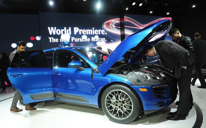 The 2014 Porsche Macan SUV attracts attention after it was unveiled to the media on November 20, 2013 at the LA Auto Show. AFP PHOTO/Frederic BROWN

