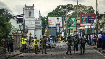 The debris of a controlled explosion in central Colombo, Sri Lanka, with St Anthony's Church in the background, April 22, 2019. Jack Moore / The National. 