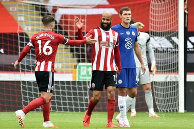 SHEFFIELD, ENGLAND - JULY 11: David McGoldrick of Sheffield United celebrates with teammate Ollie Norwood after scoring his team's first goal during the Premier League match between Sheffield United and Chelsea FC at Bramall Lane on July 11, 2020 in Sheffield, England. Football Stadiums around Europe remain empty due to the Coronavirus Pandemic as Government social distancing laws prohibit fans inside venues resulting in all fixtures being played behind closed doors. (Photo by Rui Vieira/Pool via Getty Images)