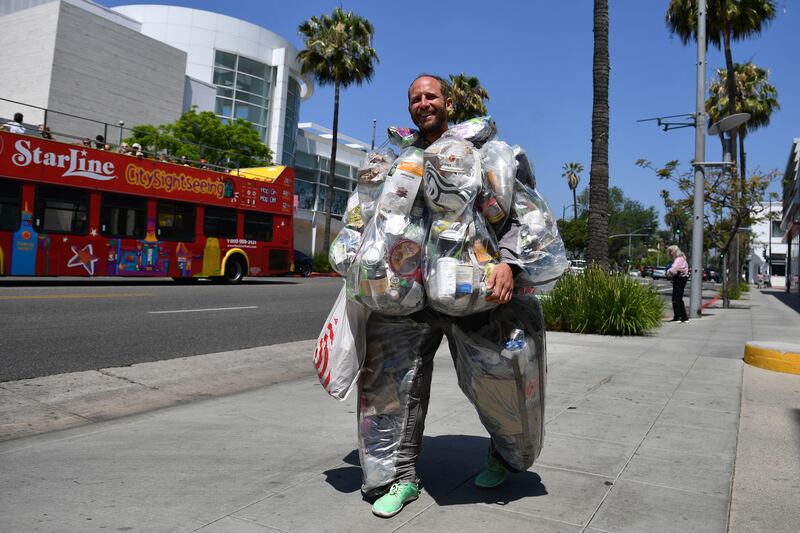 Environmental activist Rob Greenfield walks around Beverly Hills, California wearing a suit filled with every piece of rubbish he has generated merely by living and consuming like a typical American for one month. He is raising awareness about how much waste one person generates and on day 27 of the project he was wearing 28.5kg of rubbish. AFP
