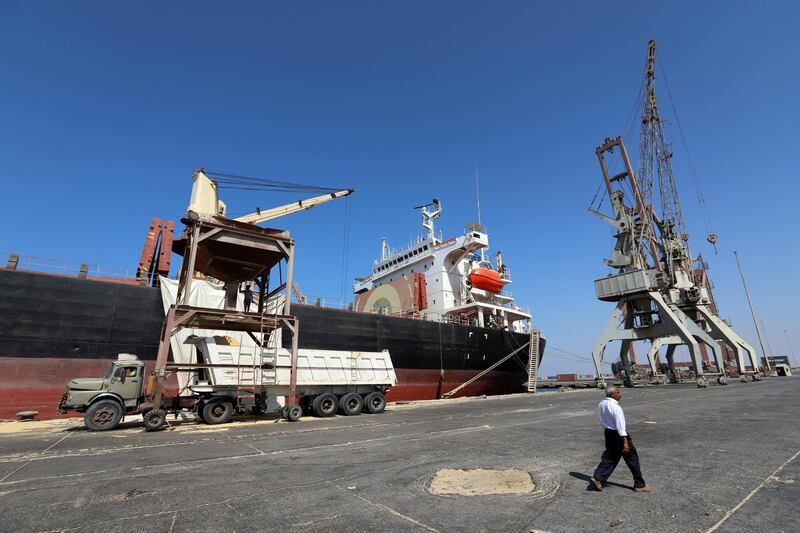 FILE PHOTO: A worker walks past a ship unloading grain at the Red Sea port of Hodeidah, Yemen, January 5, 2019. Picture taken January 5, 2019. REUTERS/Abduljabbar Zeyad/File Photo