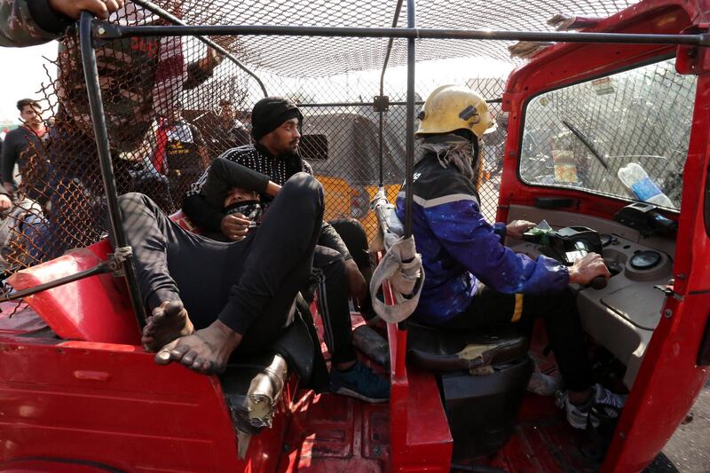 A Tuk tuk car used by Iraqi protesters to evacuate a wounded protester during clashes with anti-riot police forces at the Al-Tayaran square in central Baghdad.  EPA