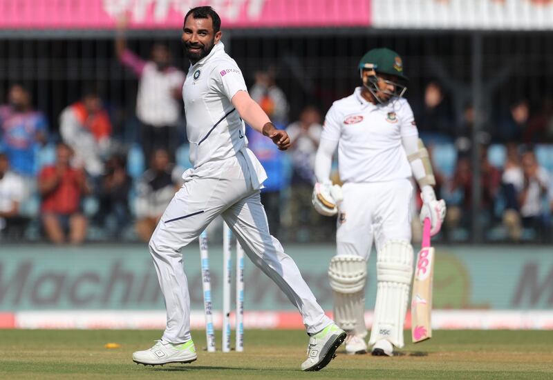 India's Mohammed Shami, left, celebrates the dismissal of Bangladesh's Mushfiqur Rahim, right, during the first day of first cricket test match between India and Bangladesh in Indore, India, Thursday, Nov. 14, 2019. (AP Photo/Aijaz Rahi)