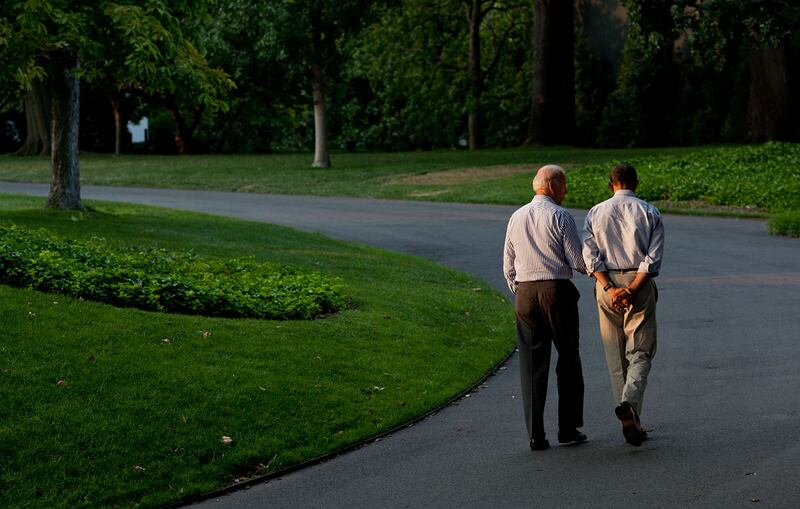 Mr Obama and Mr Biden walk around the South Lawn of the White House during a break on a working Sunday, July 24, 2011. Photo: The National Archives
