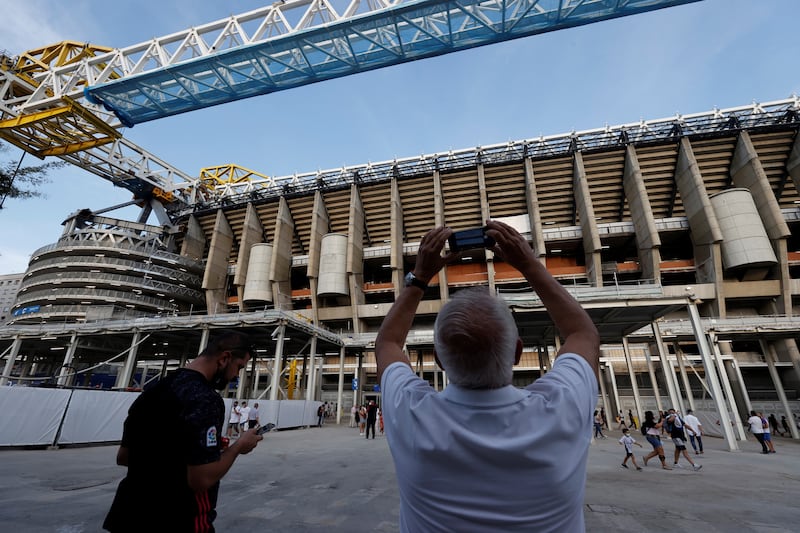 Real Madrid's fans take pictures of the construction work at the Santiago Bernabeu. EPA