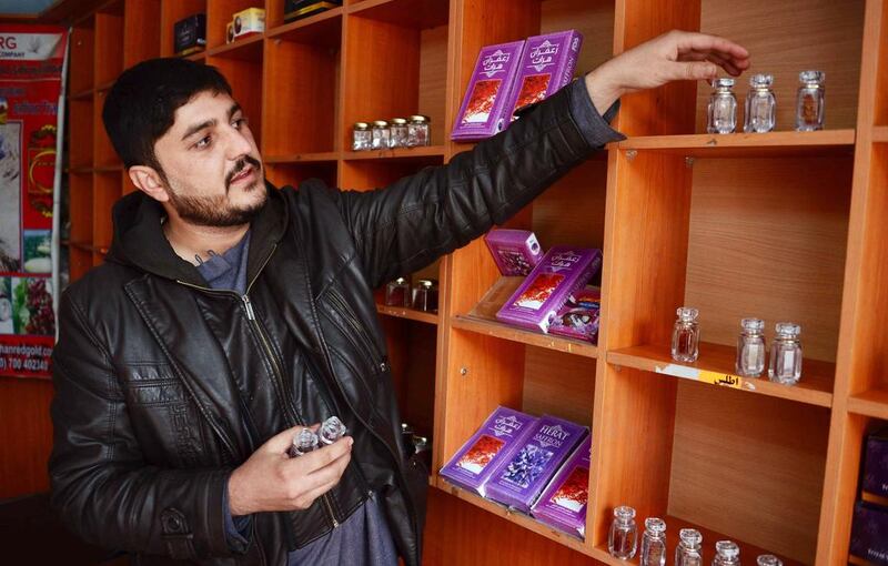 An Afghan saffron shop keeper arranges items at his shop in Herat, Afghanistan.