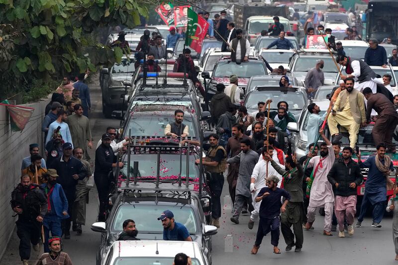 A convoy of vehicles accompanies former Pakistan prime minister Imran Khan as he leaves his home town of Lahore on Friday for a court appearance in Islamabad on Saturday.  AP
