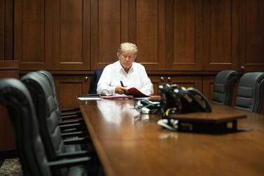 A handout image made available by the White House showing US President Donald Trump working in a conference room while receiving treatment after testing positive for Covid-19. EPA