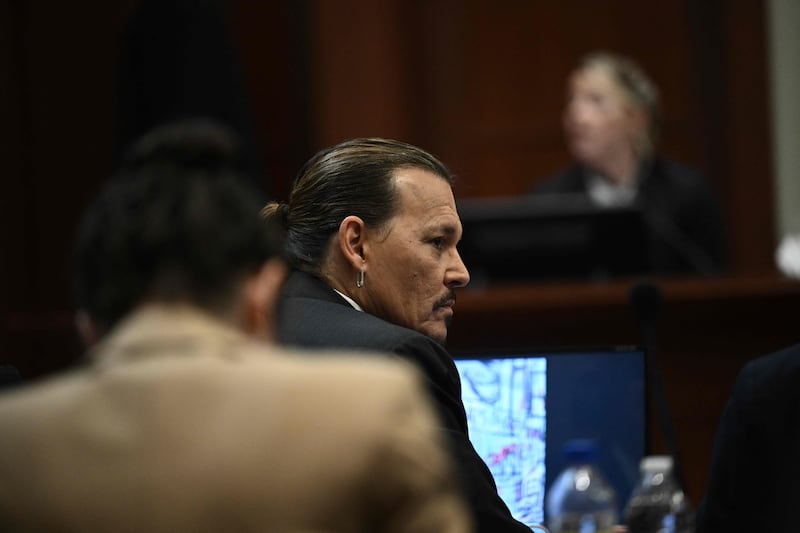 Depp listens in the courtroom. AFP