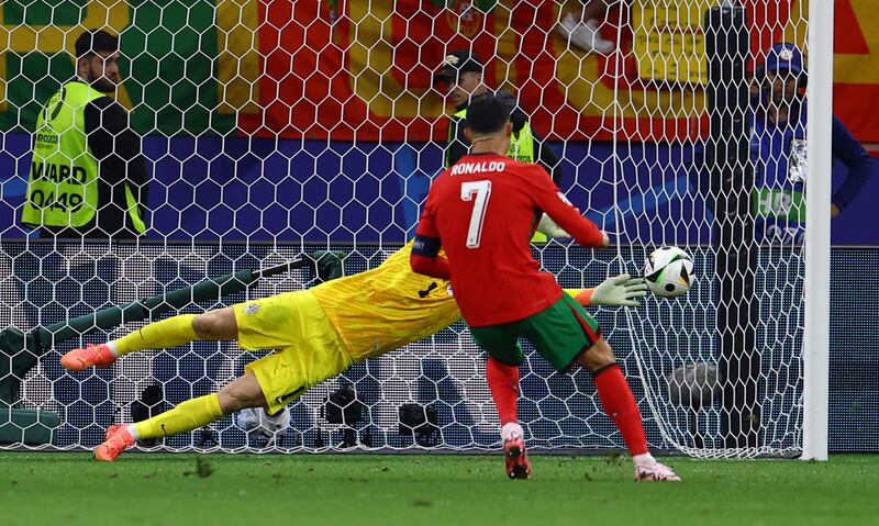 Slovenia's Jan Oblak saves a penalty from Portugal's Cristiano Ronaldo. Reuters
