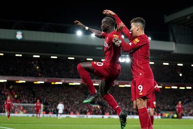 Liverpool's Sadio Mane, left, celebrates with Liverpool's Roberto Firmino. AP