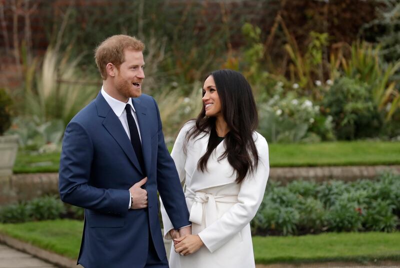 FILE - In this file photo dated  Monday Nov. 27, 2017, Britain's Prince Harry and his fiancee Meghan Markle pose for photographers in the grounds of Kensington Palace in London, following the announcement of their engagement. Speculation is mounting over who will be invited to the May 19, 2018, royal wedding of Prince Harry and Meghan Markle, with pundits guessing about the wedding guest list.   (AP Photo/Matt Dunham, FILE)